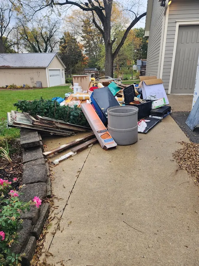 Dumpster being loaded with debris for Estate Cleanout Dumpster Rental in Estes Park
